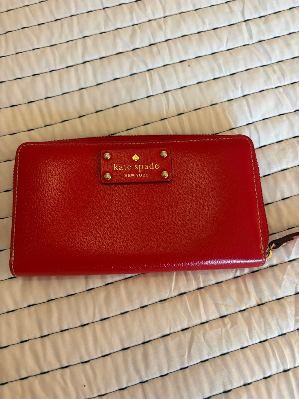 kate spade red zip-around leather wallet with gold logo